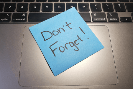 Don't Forget post-it note on keyboard