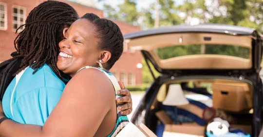 A woman hugging her son as he leaves for college