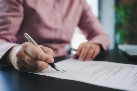 person signing a document
