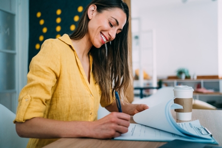 happy woman signing documents