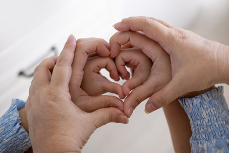 grandmother, mother, and daughter hands with heart shape